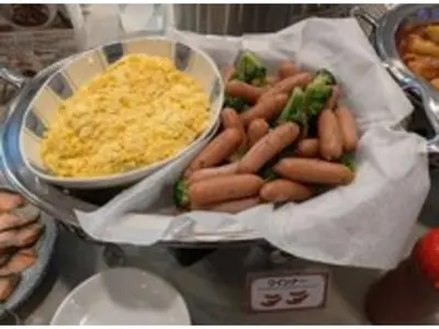 a tray of hot dogs with broccoli and cheese at Smile Hotel Tokyo Ayase Ekimae - Vacation STAY 62863v in Tokyo