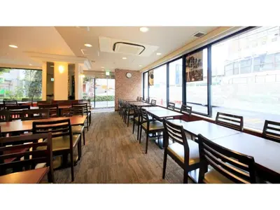 a dining room with tables and chairs and windows at Smile Hotel Tokyo Ayase Ekimae - Vacation STAY 62867v in Tokyo