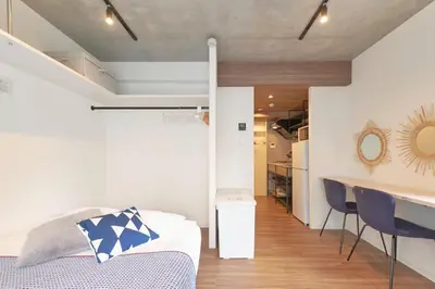 a bedroom with a bed and a desk and a kitchen at MATSUMIZAKA HILL - Vacation STAY 16610v in Tokyo