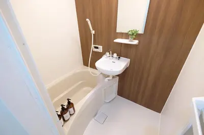 a small bathroom with a sink and a bath tub at Belshaart Kamikitazawa - Vacation STAY 20402 in Tokyo