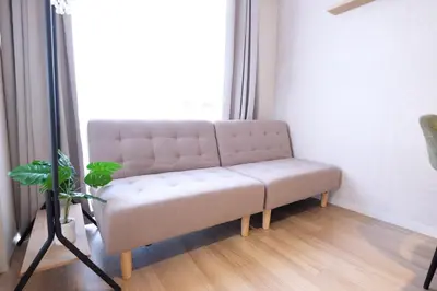 a couch sitting in a room with a window at Belshaart Kamikitazawa - Vacation STAY 20402 in Tokyo
