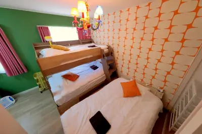 two bunk beds in a room with green walls at Kapalua East-Kapalua West - Vacation STAY 20389 in Tokyo