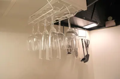 a bunch of wine glasses hanging from a rack at Kapalua East-Kapalua West - Vacation STAY 20389 in Tokyo
