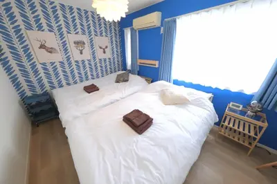 two beds in a room with blue walls at Kapalua East-Kapalua West - Vacation STAY 20389 in Tokyo
