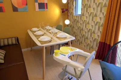 a table with dishes and a chair in a room at Kapalua East-Kapalua West - Vacation STAY 20389 in Tokyo