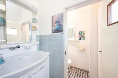 a bathroom with a sink and a toilet and a mirror at Miki Building 4F - Vacation STAY 20370 in Tokyo