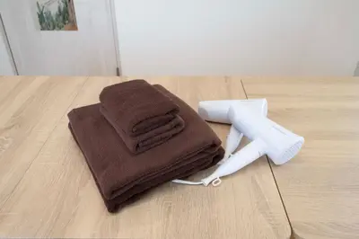 a pile of towels and a hair dryer on a table at Miki Building 4F - Vacation STAY 20370 in Tokyo