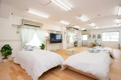 a bedroom with two beds and a flat screen tv at Miki Building 4F - Vacation STAY 20370 in Tokyo