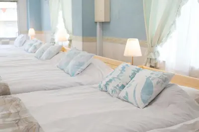 a row of beds with blue and white pillows at Miki Building 4F - Vacation STAY 20370 in Tokyo