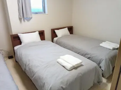 two beds in a room with white sheets and towels at K,AND,M,OOIMACHI - Vacation STAY 60966v in Tokyo