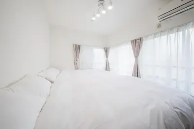 a white bed in a bedroom with a window at Kitakoiwakotate - Vacation STAY 20435 in Tokyo