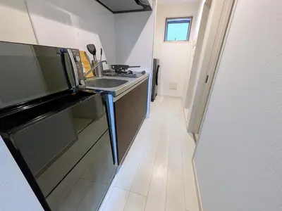 a small kitchen with a sink and a counter at Han Homes Omorihoncho in Tokyo