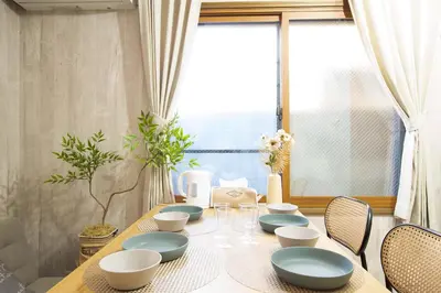 a dining room table with blue and white dishes on it at ever Inn Asagaya in Tokyo