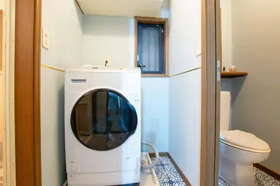 a washing machine in a bathroom with a toilet at ever Inn Asagaya in Tokyo