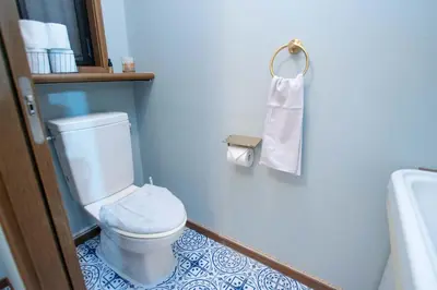 a bathroom with a toilet and a roll of toilet paper at ever Inn Asagaya in Tokyo