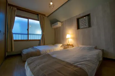 a hotel room with two beds and a window at ever Inn Asagaya in Tokyo