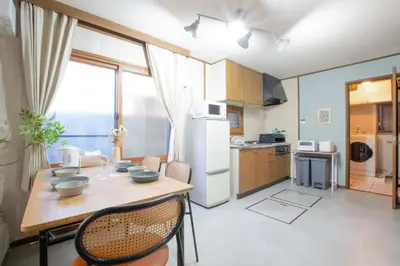 a kitchen and dining room with a table and chairs at ever Inn Asagaya in Tokyo