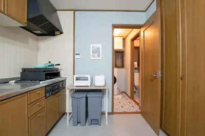 a kitchen with a stove and a counter top at ever Inn Asagaya in Tokyo