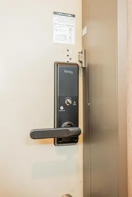 a refrigerator with a card dispenser on the wall at 201 6-min walk from Higashi-Jūjō Station Cozy 1-Bedroom Apartment Direct Access to Akihabara & Ueno in Tokyo