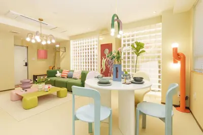 a living room with a couch and a table and chairs at \u5bc5\u30db\u30c6\u30eb \u5fa1\u5f92\u753a Tora Hotel Okachimachi in Tokyo