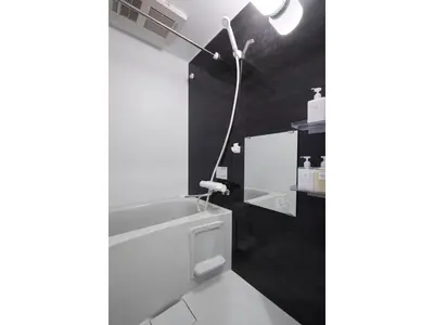 a bathroom with a white tub and a light on the wall at LIFE TOWN OSHIAGE - Vacation STAY 20457 in Tokyo