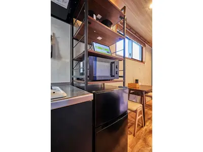 a kitchen with a black refrigerator and a table at LIFE TOWN OSHIAGE - Vacation STAY 20457 in Tokyo
