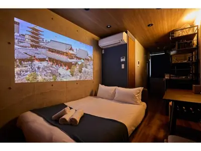 a bed in a room with a painting on the wall at LIFE TOWN OSHIAGE - Vacation STAY 20459 in Tokyo