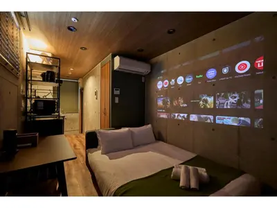 a bedroom with a bed and a wall with stickers at LIFE TOWN OSHIAGE - Vacation STAY 20462 in Tokyo
