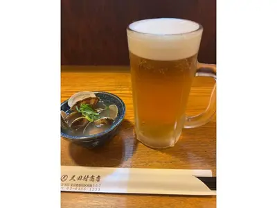 a glass of beer and a plate of food on a table at LIFE TOWN OSHIAGE - Vacation STAY 20463 in Tokyo