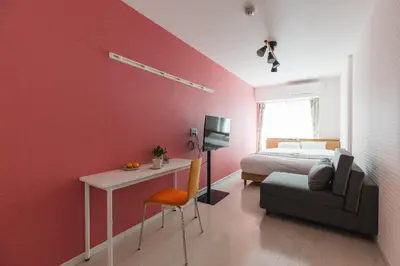 a bedroom with a bed and a desk and a bed and a chair at ViLLA SAKURA\u65d7\u306e\u53f0 II\u756a\u9928 in Tokyo