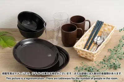 a table with black plates and cups and a basket at ViLLA SAKURA\u65d7\u306e\u53f0 II\u756a\u9928 in Tokyo