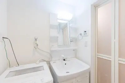a white bathroom with a sink and a mirror at ViLLA SAKURA\u65d7\u306e\u53f0 II\u756a\u9928 in Tokyo