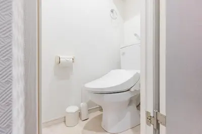 a white bathroom with a toilet and a shower at ViLLA SAKURA\u65d7\u306e\u53f0 II\u756a\u9928 in Tokyo