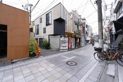 a bike parked on a city street with buildings at House Hotel Nakano TNA in Tokyo
