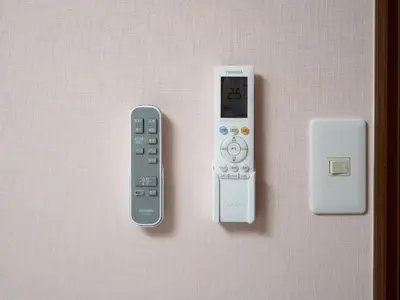 a remote control and an electronic device on a wall at Familia Kamata 1 in Tokyo
