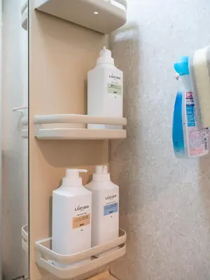 a closet with bottles of laundry detergent and towels at Familia Kamata 1 in Tokyo