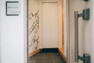 a hallway with a door and a tile floor at Metronest \u4e09\u8ed2\u8336\u5c4b in Tokyo