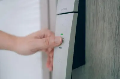 a person is pressing a button on an appliance at Metronest \u4e09\u8ed2\u8336\u5c4b in Tokyo