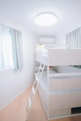 a white bunk bed in a room with a ladder at Metronest \u4e09\u8ed2\u8336\u5c4b in Tokyo