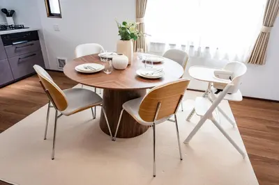 a dining room with a wooden table and chairs at Lille Kameari in Tokyo