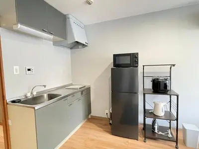 a small kitchen with a sink and a refrigerator at \u30a2\u30e0\u30db\u30c6\u30eb in Tokyo
