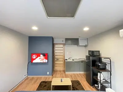 a living room with a table and a kitchen at \u30a2\u30e0\u30db\u30c6\u30eb in Tokyo