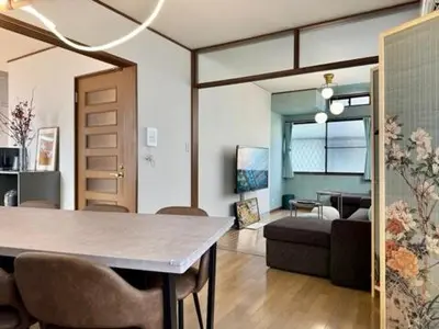 a living room with a table and a couch at Oji kajiwara house in Tokyo