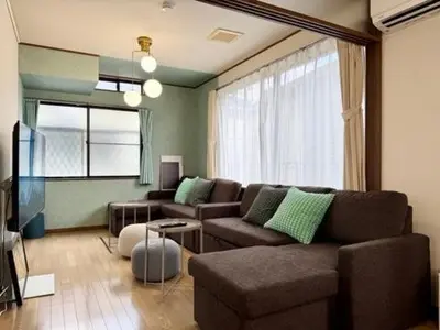a living room with a couch and a tv at Oji kajiwara house in Tokyo