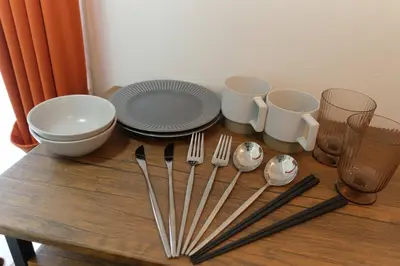 a table with forks and plates and utensils on it at monthly Sakura Yoyogi in Tokyo