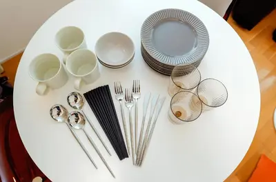 a white table with plates and silverware on it at monthly Sakura Yoyogi in Tokyo