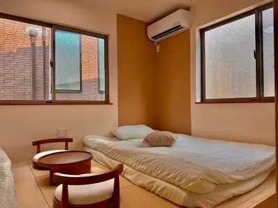 a bedroom with a bed and a table and two windows at D\u8c4a\u5cf6\u533a\u6700\u4e2d\u5fc3 \u4e24\u5ba4 \u99d2\u8fbc\u7ad95\u5206-2 rooms Toshima center 5 mins to ST Max 4P \u65b0\u5bbf \u6d89\u8c37 \u8868\u53c2\u9053 \u6c60\u888b \u4e0a\u91ce \u4ee3\u4ee3\u6728 \u94f6\u5ea7 \u539f\u5bbf in Tokyo