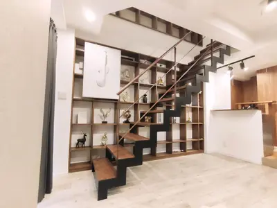 a staircase in a living room with wooden shelves at \u8fd1\u4e0a\u91ce \u5168\u65b0\u88c5\u4fee 2\u5ba41\u53851\u6d74\u5ba41\u536b\u751f\u95f4 \u8bbe\u65bd\u9f50\u5168 \u6700\u59275\u4eba Ueno 2 rooms 1dining room 1 bathrooms 1toilets Max 5P in Tokyo