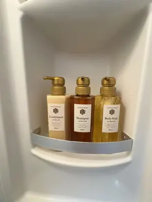 three bottles of honey on a shelf in a refrigerator at \u79cb\u306e\u65c5\u9928 in Tokyo