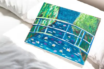 a painting of a window with flowers on a bed at Kotori Itabashi in Tokyo